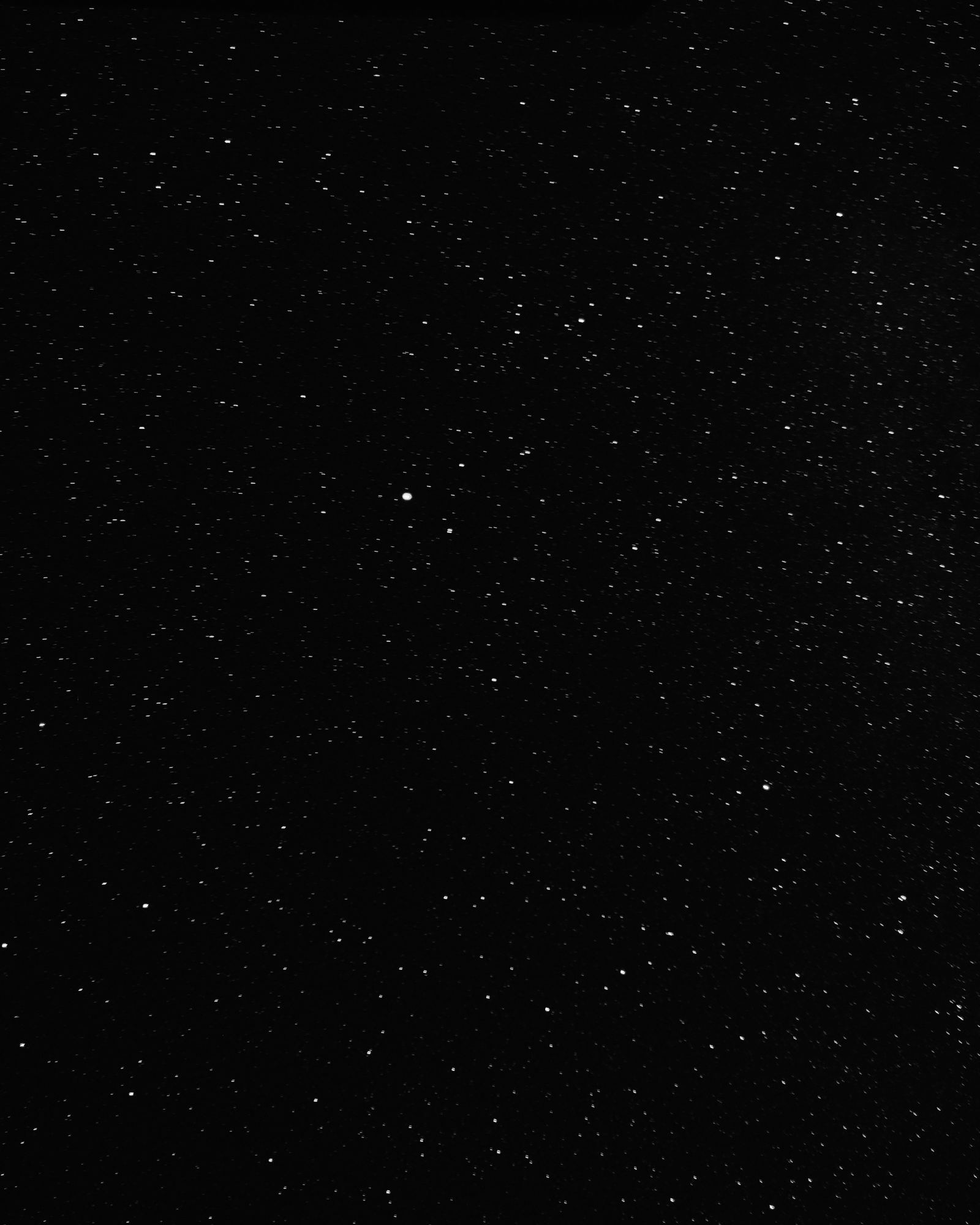 A dense starfield with a faint blue nebula glow